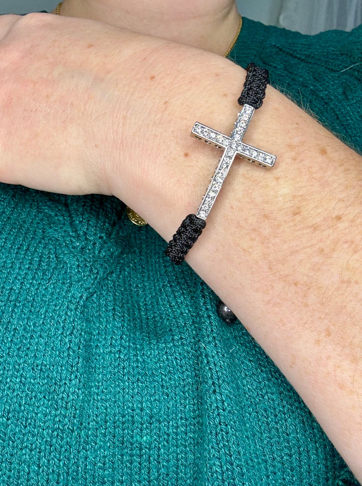 This stunning bracelet features a sleek black braided design that can easily be adjusted for the perfect fit. It's a versatile piece that can be given as a meaningful gift or kept as a treasured accessory for yourself!