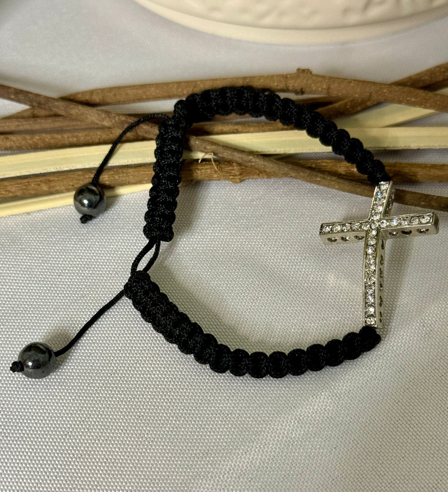 This stunning bracelet features a sleek black braided design that can easily be adjusted for the perfect fit. It's a versatile piece that can be given as a meaningful gift or kept as a treasured accessory for yourself!