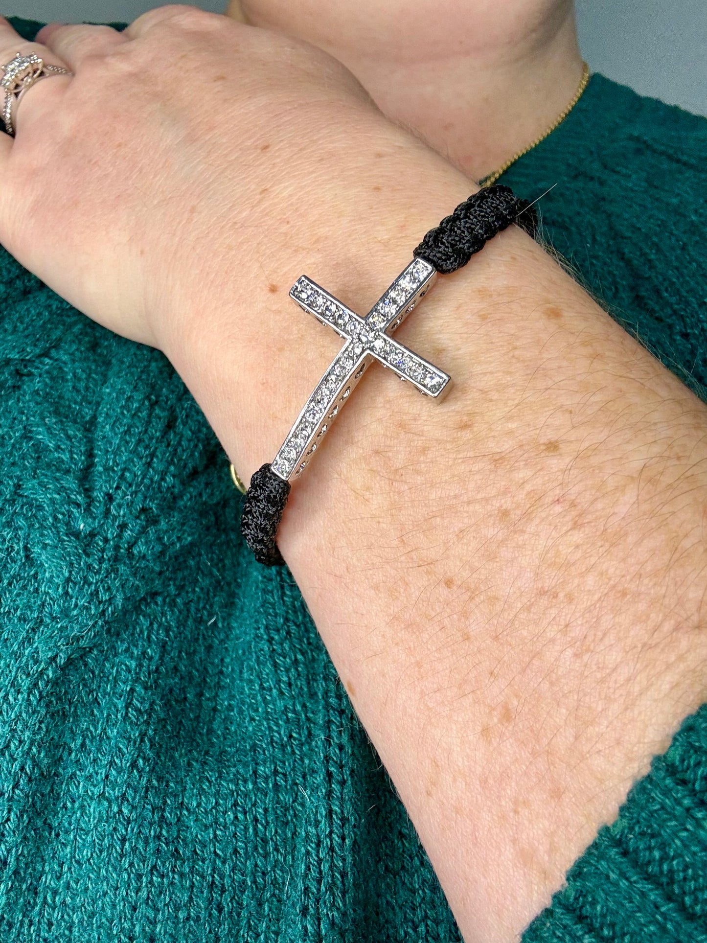 This stunning bracelet features a sleek black braided design that can easily be adjusted for the perfect fit. It's a versatile piece that can be given as a meaningful gift or kept as a treasured accessory for yourself!