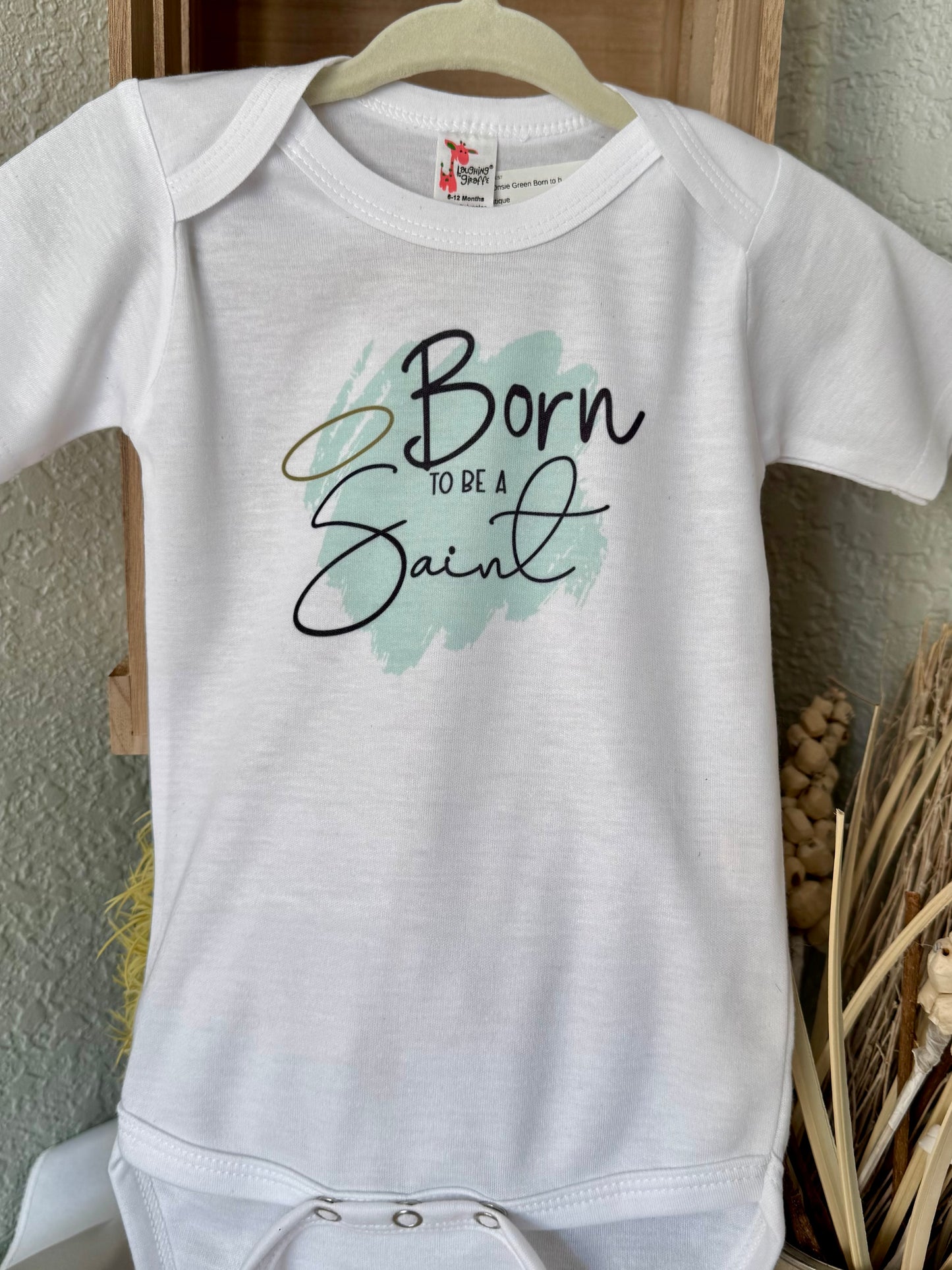 Born to Be a Saint Baby Onesie - Laughing Giraffe